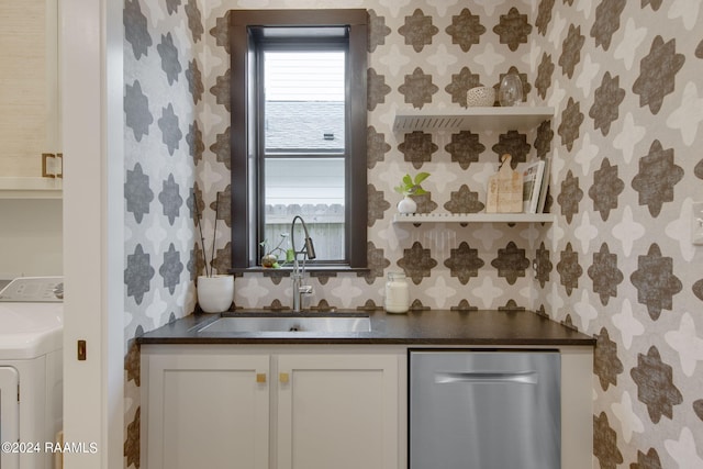 kitchen featuring washer / dryer, white cabinetry, sink, and dishwasher