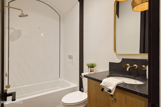 full bathroom featuring tiled shower / bath, vanity, and toilet