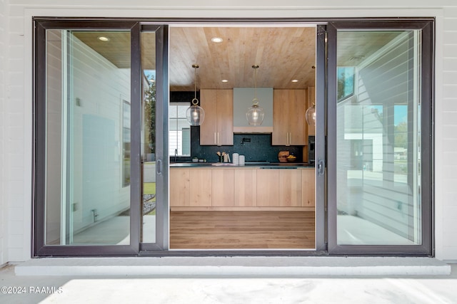 interior space with wood ceiling, tasteful backsplash, and vanity