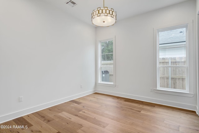 spare room with light hardwood / wood-style floors