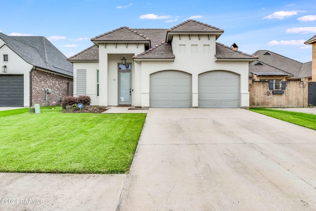 view of front of house featuring a garage and a front lawn