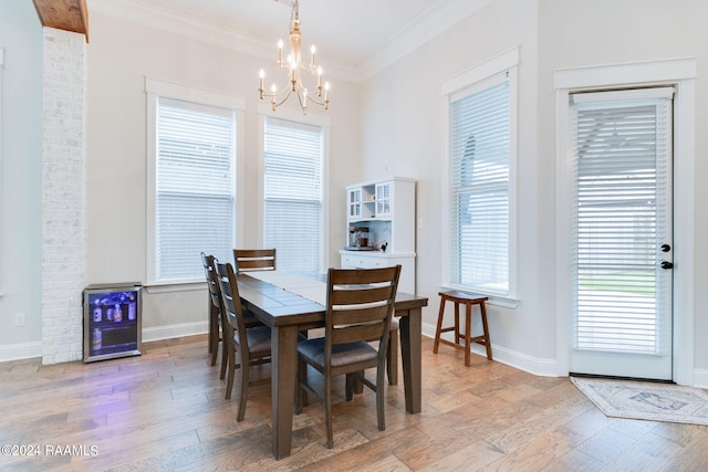 dining room featuring a wealth of natural light, a notable chandelier, and hardwood / wood-style floors