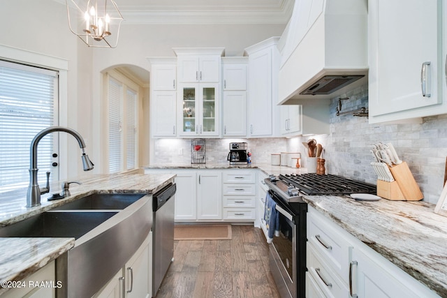 kitchen with white cabinets, an inviting chandelier, custom range hood, appliances with stainless steel finishes, and dark hardwood / wood-style floors