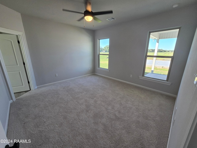 empty room with light carpet and ceiling fan