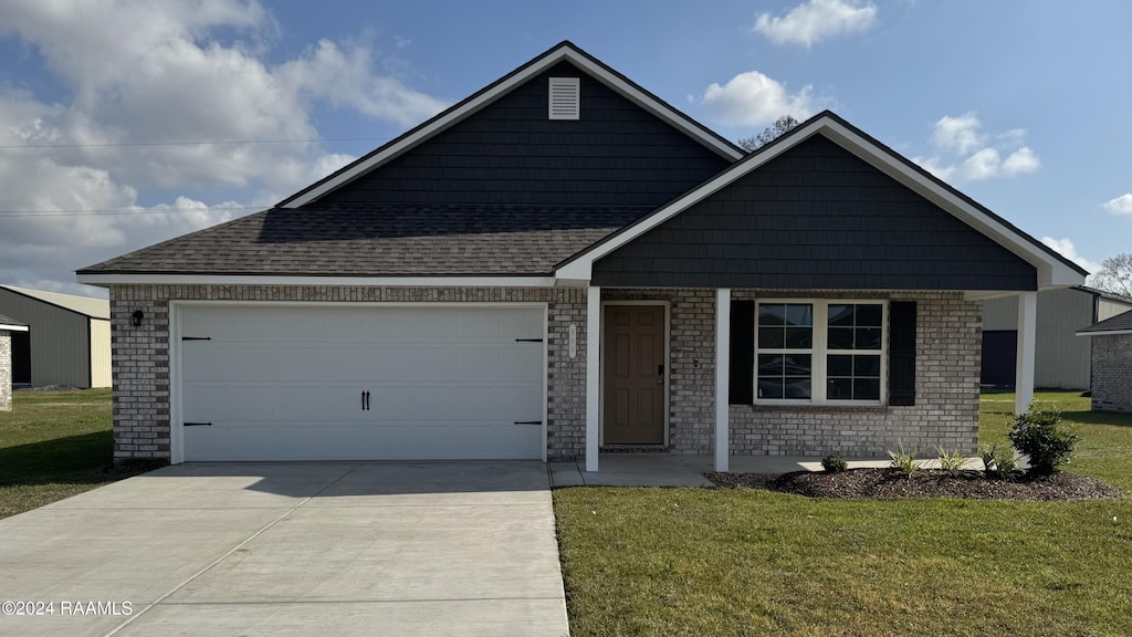 view of front of house with a garage and a front yard