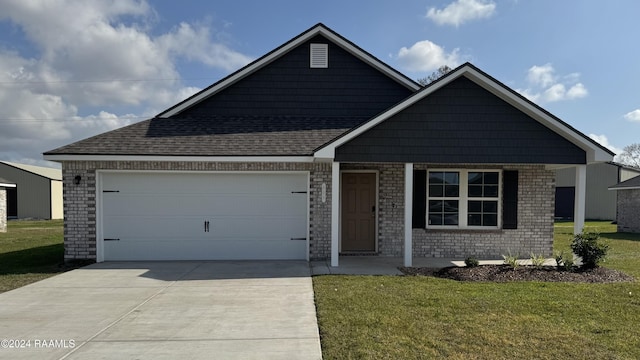 view of front of house with a garage and a front yard