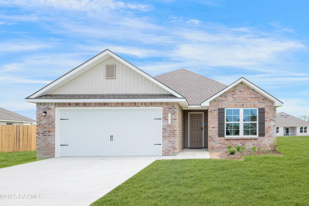 view of front of house featuring a garage and a front lawn