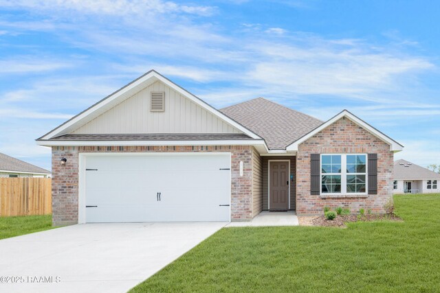 view of front of house featuring a garage and a front lawn