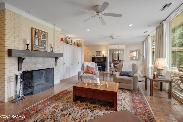 living room with crown molding, a fireplace, and ceiling fan with notable chandelier