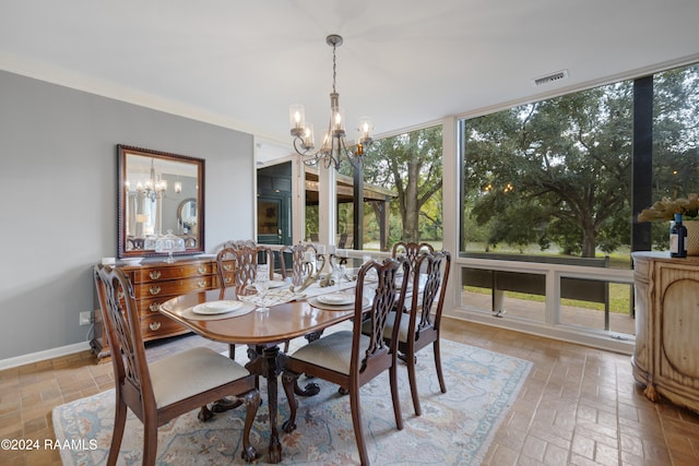 dining room featuring crown molding and a chandelier