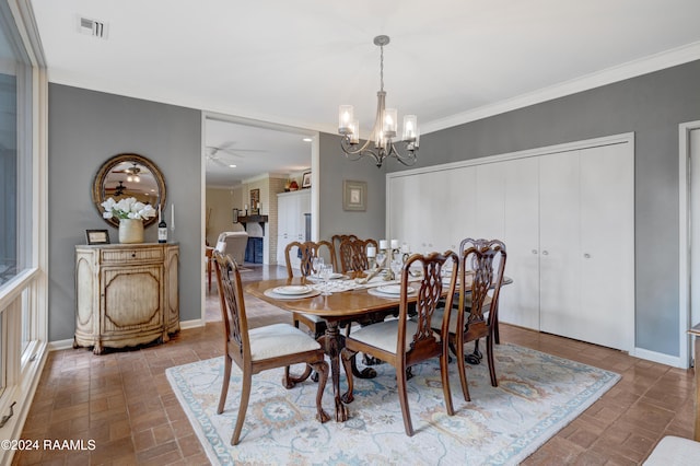 dining space featuring crown molding and ceiling fan with notable chandelier