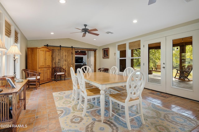 dining room featuring lofted ceiling, french doors, a barn door, and ceiling fan