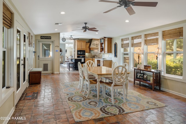 dining space with sink, ceiling fan, and lofted ceiling