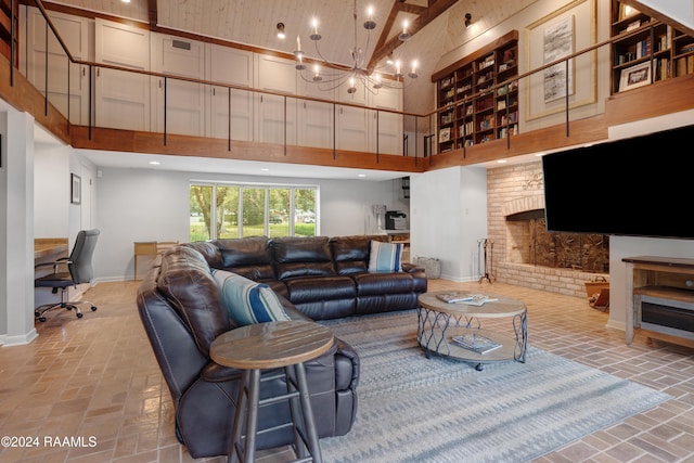 living room with a towering ceiling, a chandelier, and beamed ceiling