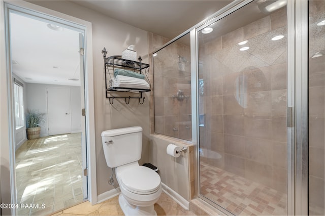 bathroom with toilet and an enclosed shower