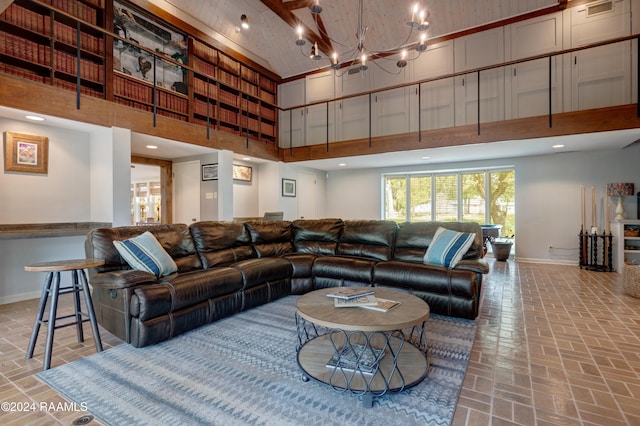 living room with a towering ceiling and an inviting chandelier