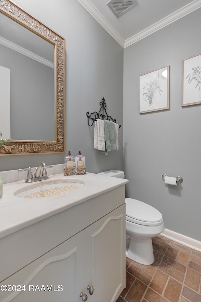 bathroom featuring vanity, toilet, and ornamental molding