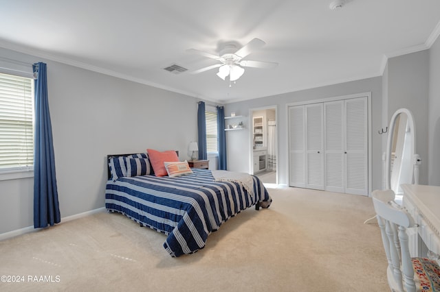 carpeted bedroom featuring connected bathroom, crown molding, a closet, and ceiling fan