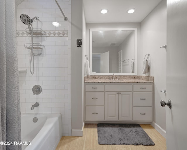 bathroom with shower / tub combo with curtain, vanity, and wood-type flooring