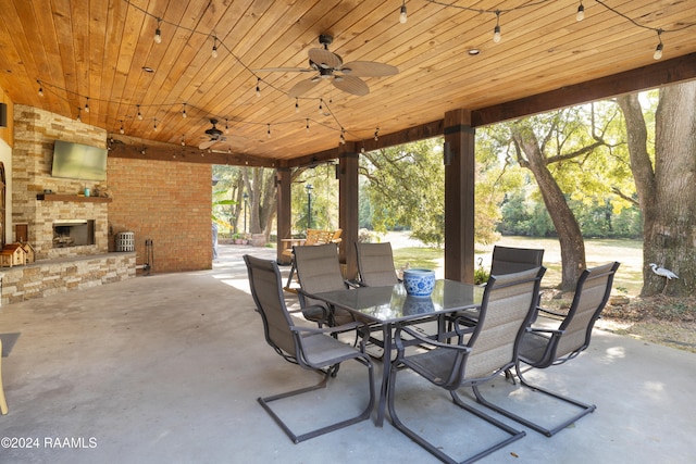 view of patio / terrace with ceiling fan and an outdoor stone fireplace