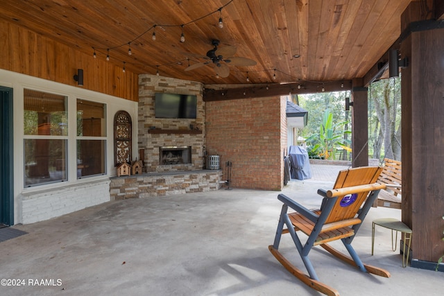 view of patio / terrace with ceiling fan and an outdoor stone fireplace