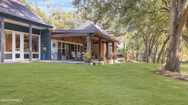 view of yard with a patio and ceiling fan