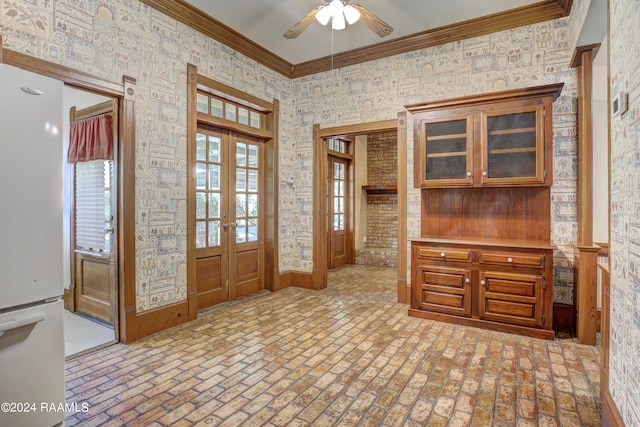 foyer entrance with ceiling fan and crown molding