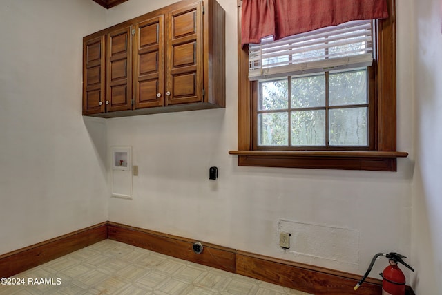 washroom featuring washer hookup and cabinets