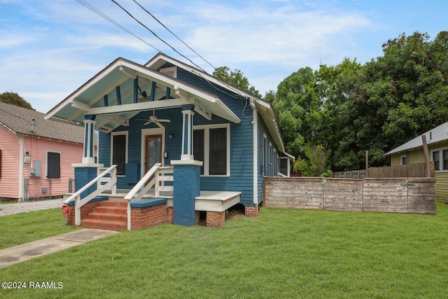 bungalow featuring a front yard and covered porch