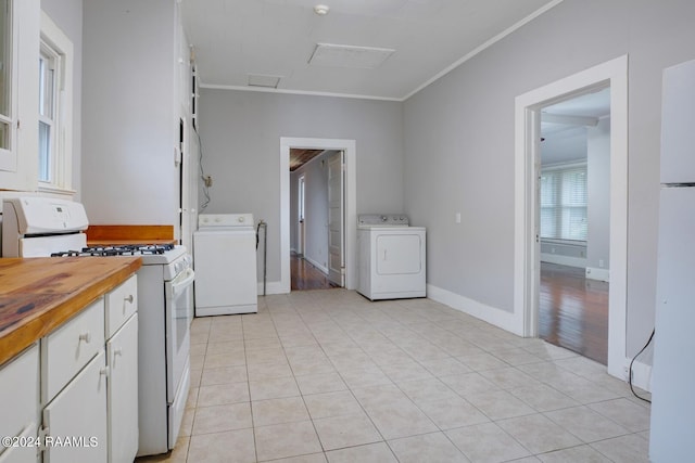 kitchen featuring white cabinetry, white appliances, and washer / clothes dryer