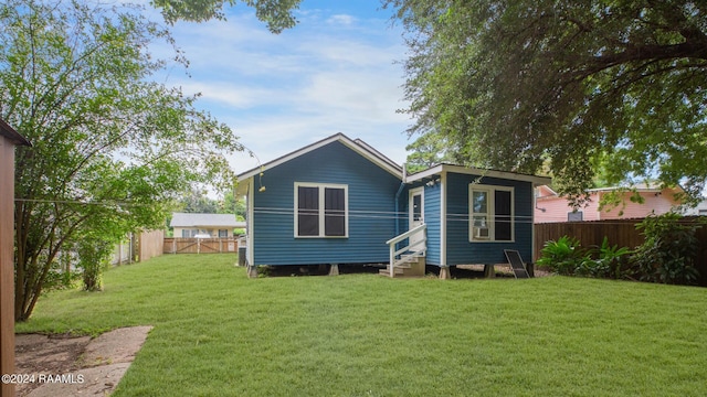 back of property featuring a lawn