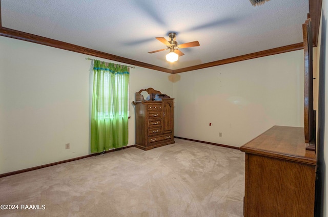 unfurnished bedroom with a textured ceiling, ornamental molding, and light carpet