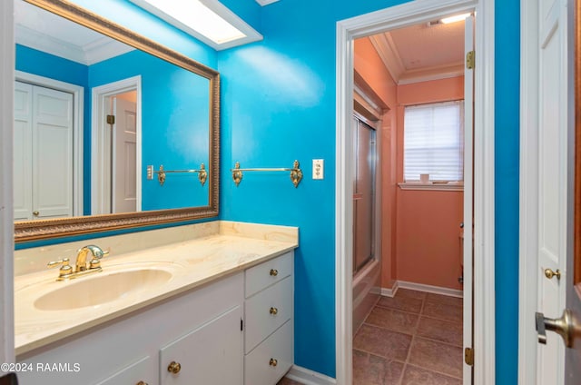 bathroom with ornamental molding, tile patterned flooring, and vanity