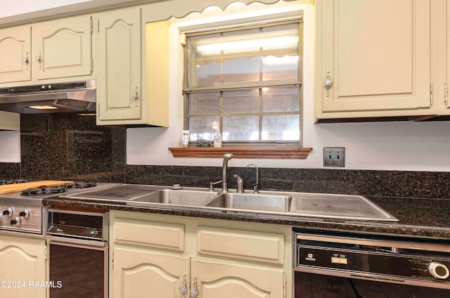 kitchen featuring dishwasher, cream cabinetry, tasteful backsplash, and tile patterned floors