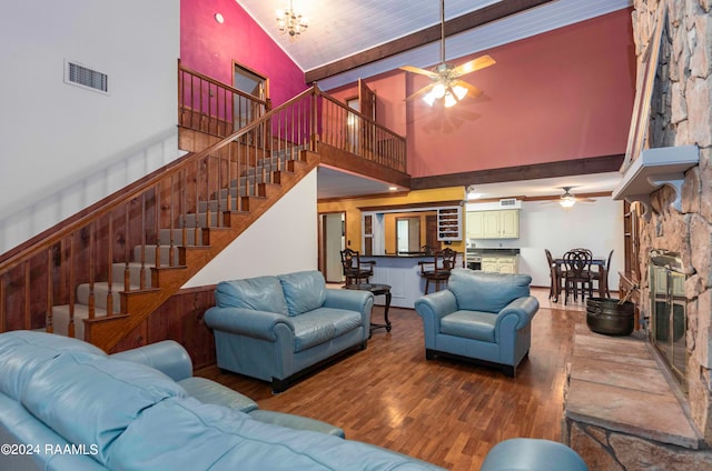 living room featuring high vaulted ceiling, ceiling fan with notable chandelier, and hardwood / wood-style flooring