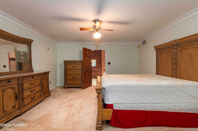 bedroom with a textured ceiling, ornamental molding, ceiling fan, and light colored carpet