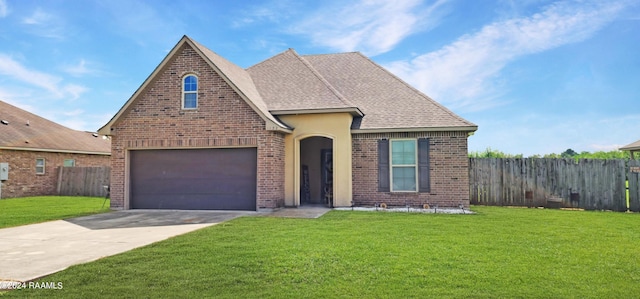 view of front of home with a garage and a front lawn