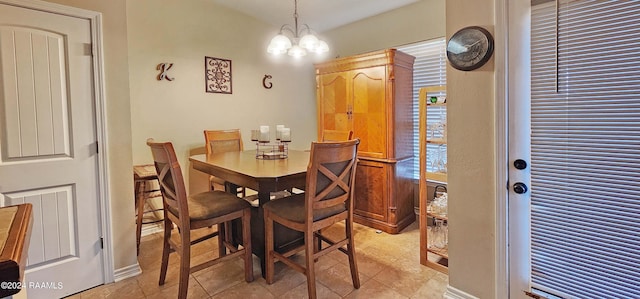 dining room featuring light tile patterned floors and a chandelier