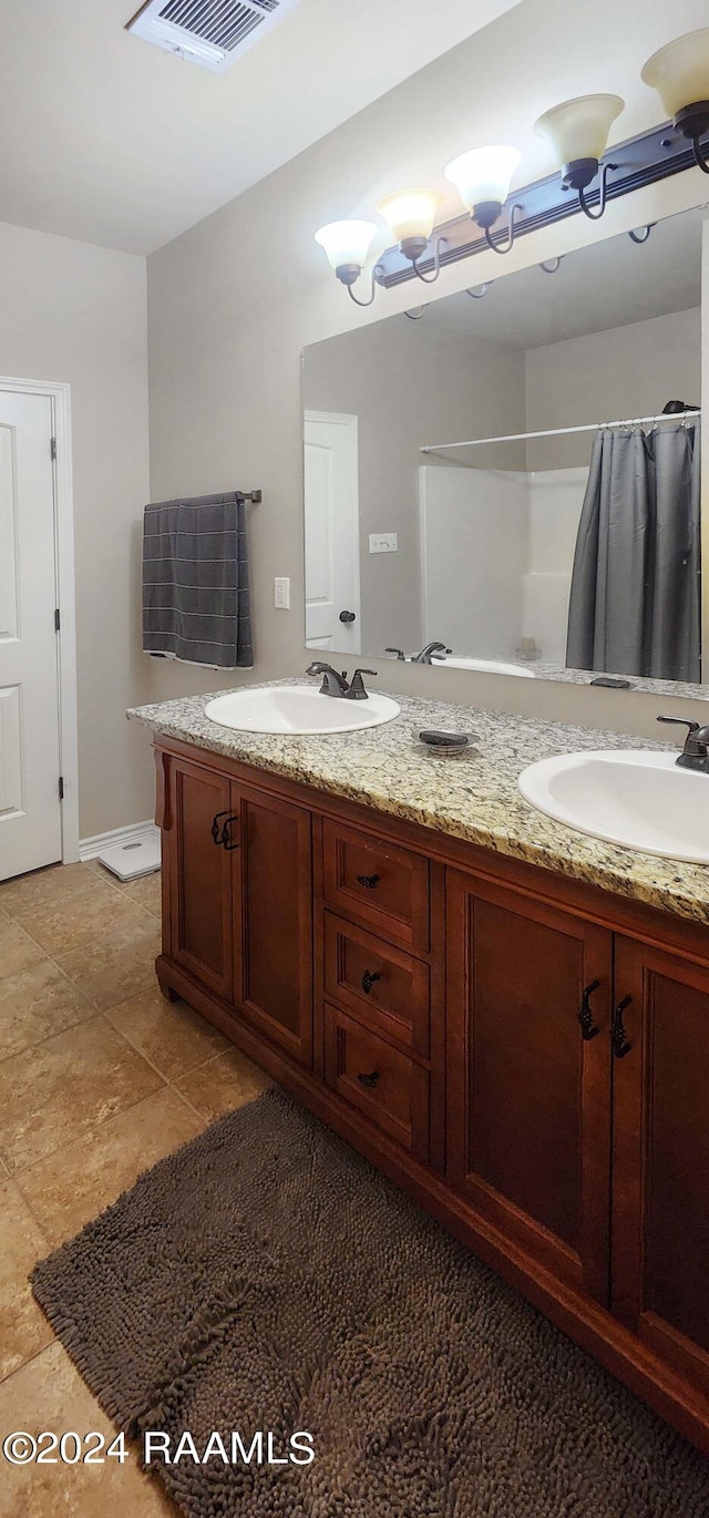 bathroom featuring walk in shower and vanity