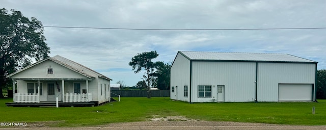 view of outbuilding featuring a lawn and covered porch