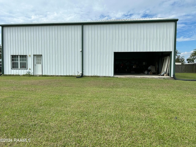 view of outbuilding featuring a lawn