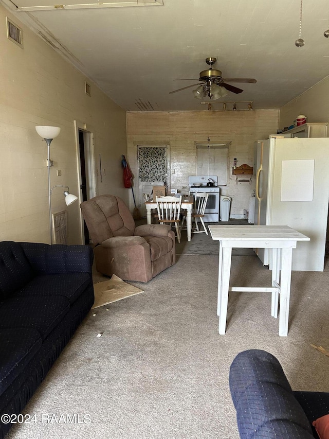 living room with ceiling fan and carpet flooring