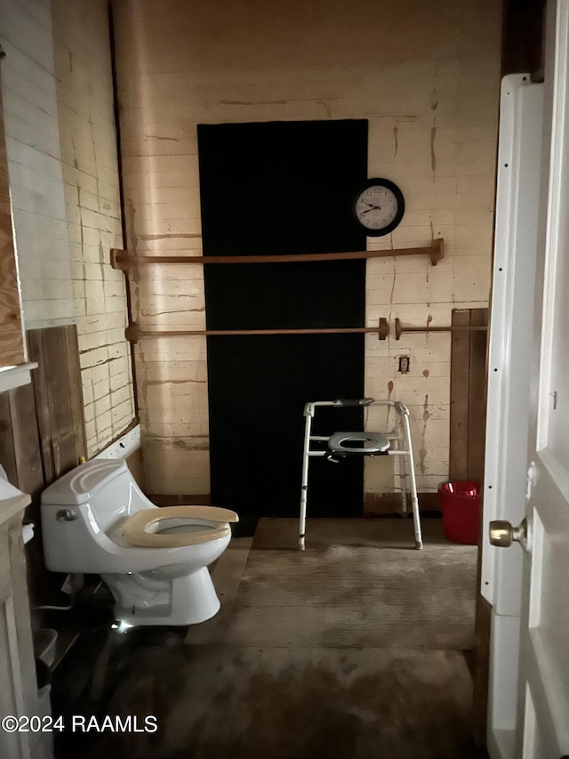 bathroom with toilet and concrete floors