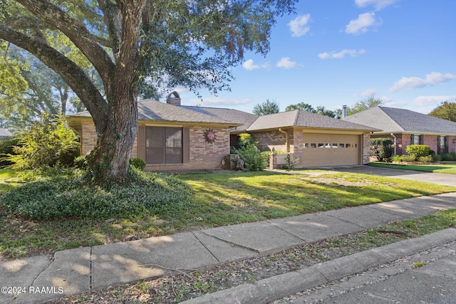 ranch-style house featuring a front lawn and a garage