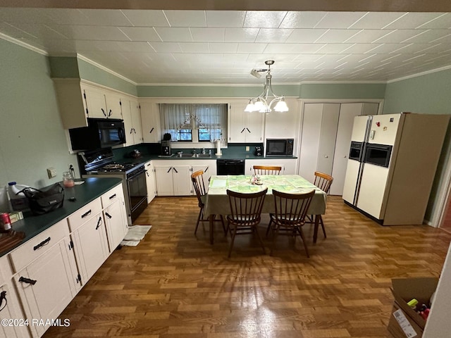 kitchen featuring hanging light fixtures, white cabinets, black appliances, crown molding, and an inviting chandelier