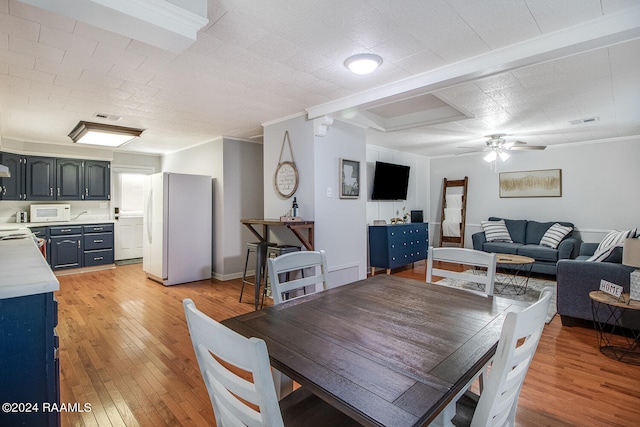 dining area with crown molding, light hardwood / wood-style floors, and ceiling fan