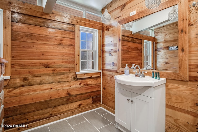 bathroom with vanity and wooden walls