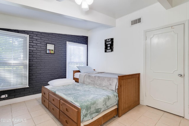 155 Emerite Dr, Lafayette, LA 70506 - bedroom featuring light tile patterned floors and brick wall