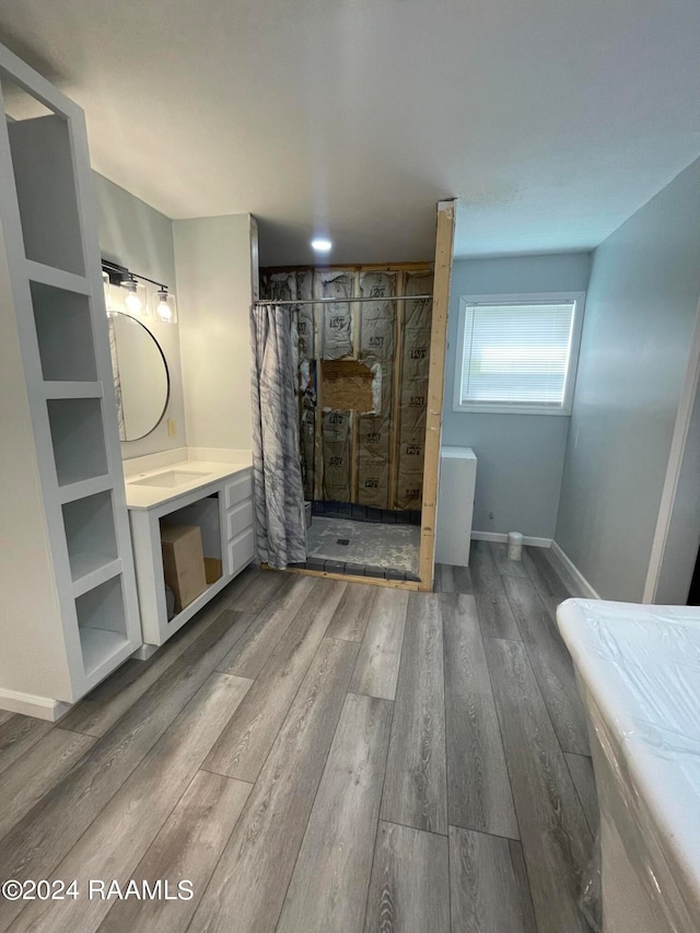 bathroom with vanity, curtained shower, and hardwood / wood-style flooring