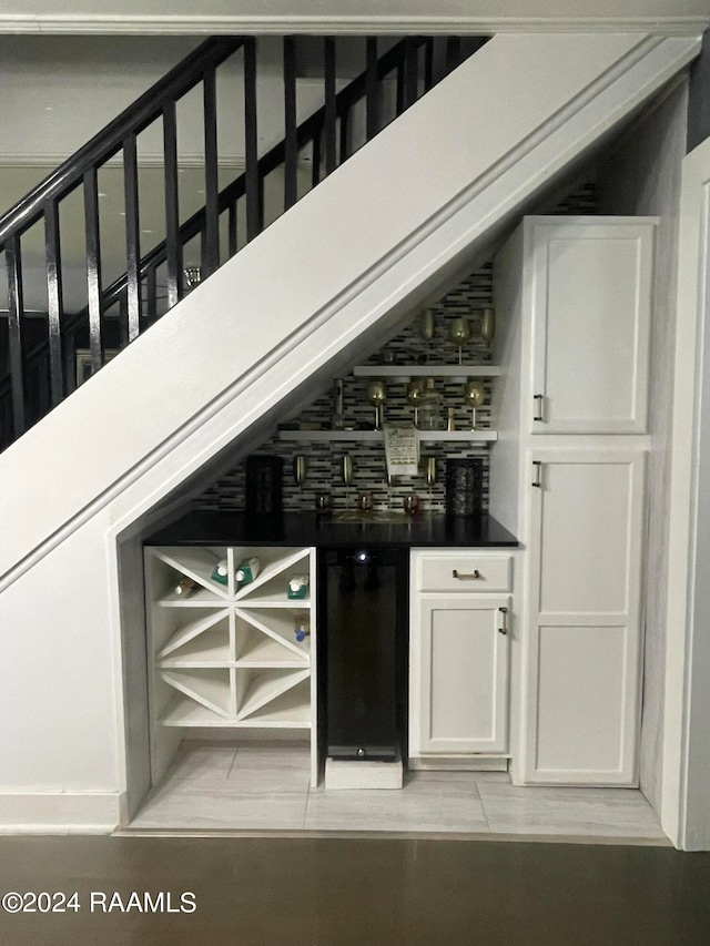 bar featuring white cabinetry